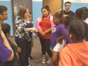 Photo by Moises Ledesma On Sept. 22, Kathryn Garcia (center left), the adviser for the Spanish activities club, and Spanish activity club members instructed children at the Boys and Girls Club.