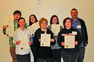 Back row from left: Joseph McDaniel, Catie Sullivan, Kayley Agan and Josh Maddox and front row Olivia Fortner, Nick Whitmire and Michelle Hardin are holding the awards that were won by Six Mile Post at the Georgia Collegiate Press Association. Contributed Photo