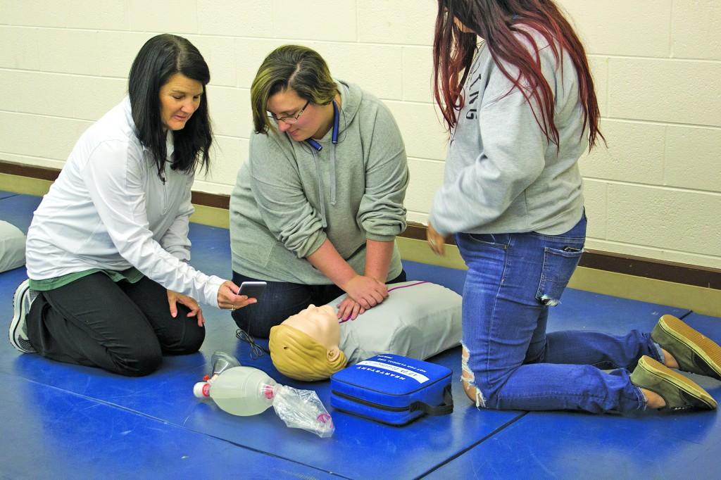  Riaz teaches students how to do CPR. Photo by Kayley Agan