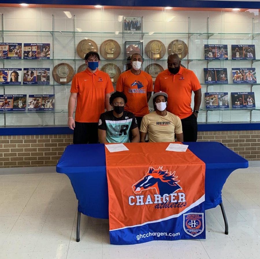Players and coaches take a picture after signing to their individual schools.
Pictured above: Cahiem Brown (bottom left), Langston Wilson (bottom right), Greg Schiefen (top left), J.J. Merritt (top middle) and John Williams (top right).