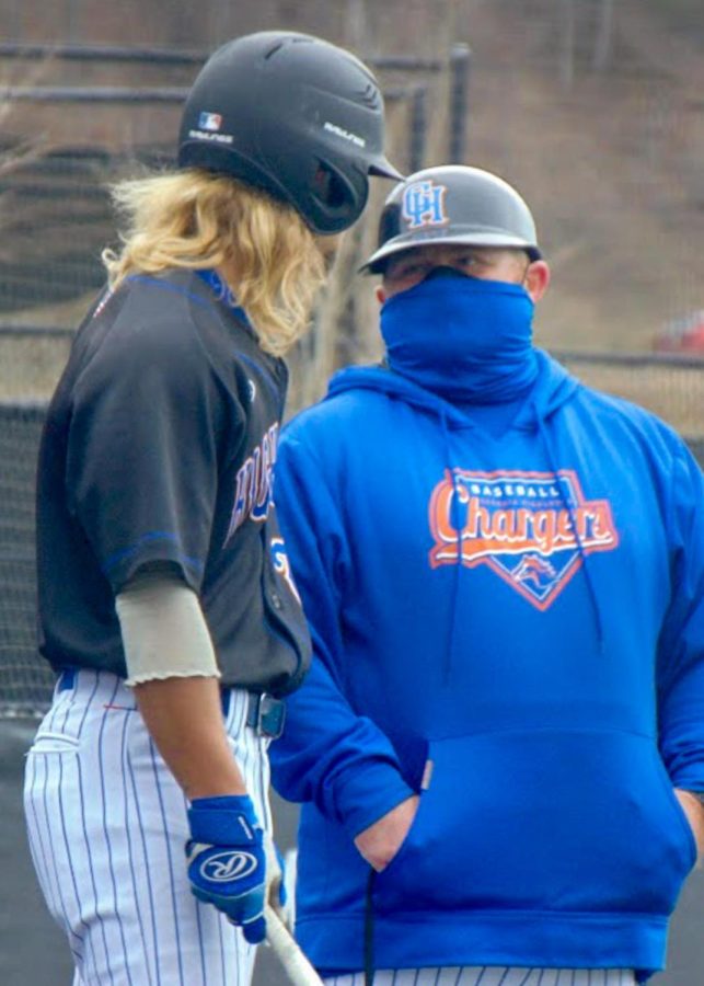 Chargers baseball head coach Danyel O'Neill gives Gavin Harmon advice on his upcoming at-bat during their game against the Triton College Trojans on March 2, 2021.