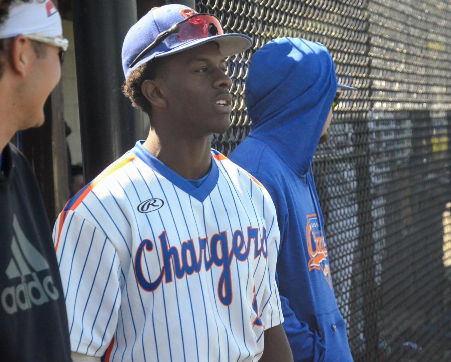 Chargers player Zayd Brannigan looks on as he awaits his turn to bat in their game against Gordon State College on April 19, 2022.