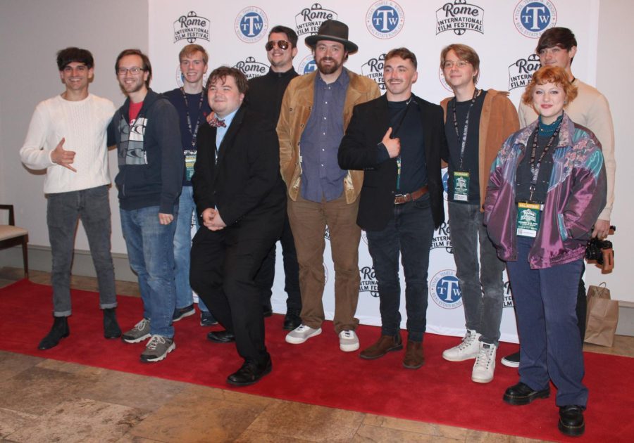 The cast and crew of Backpack in the Alley pose for photographers on the red carpet inside DeSoto Theater after the premiere of the short film.