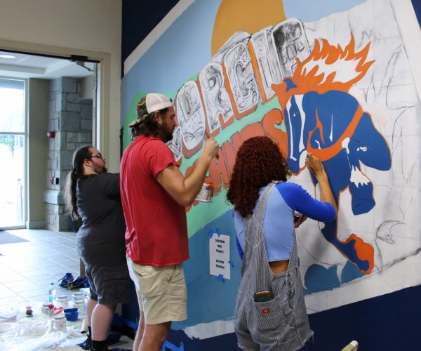 Applied Studio Art students, Cameron Brown, Kyle Garriga and Alyssa Jones working on the new GHC mural in Cartersville.