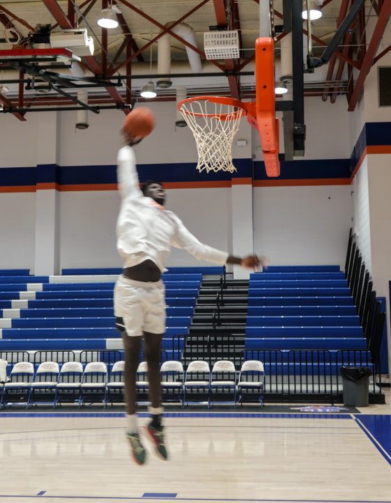 Sagna Ousseynou practices his dunking technique on the court.