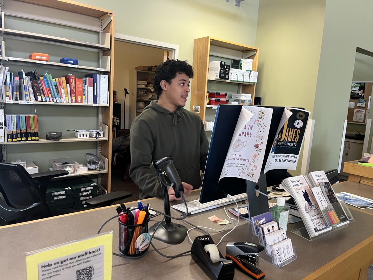 Library student assistant Byron Johnson helps with computer tasks.