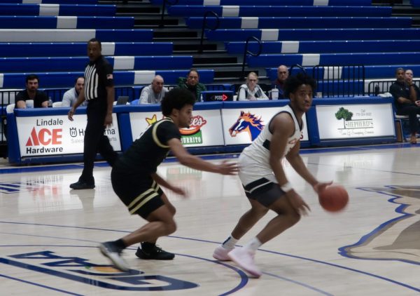 Jordan Johnson (1) sprints with the ball down the court.