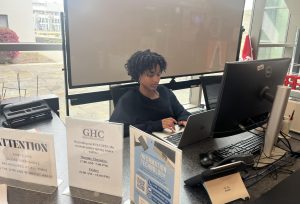 Student assistant Jada James sits at the front desk in the Cartersville campus Student Center.